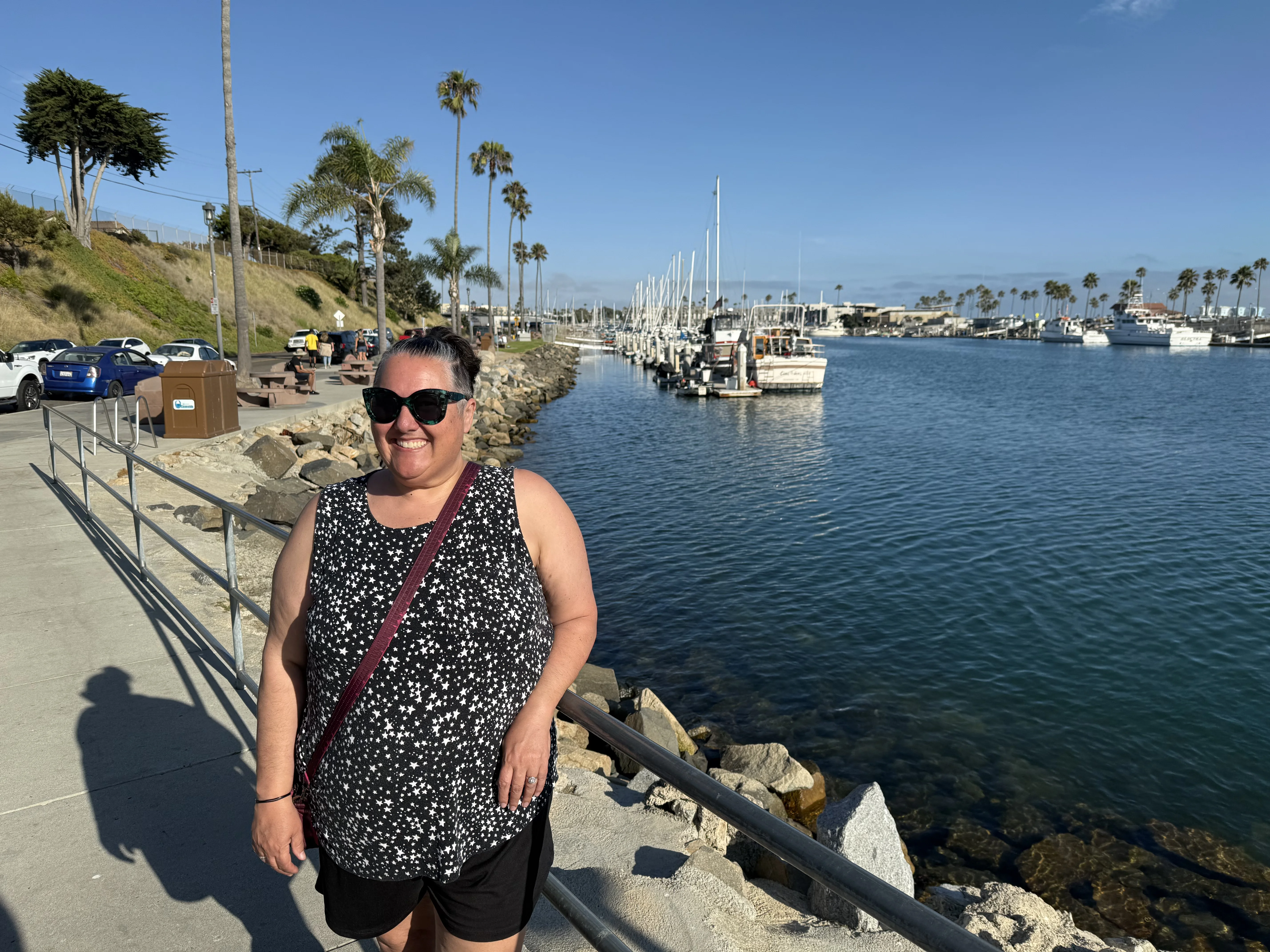 Sarah standing by the water