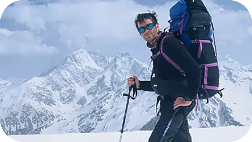 a person with a backpack on a snowy mountain
