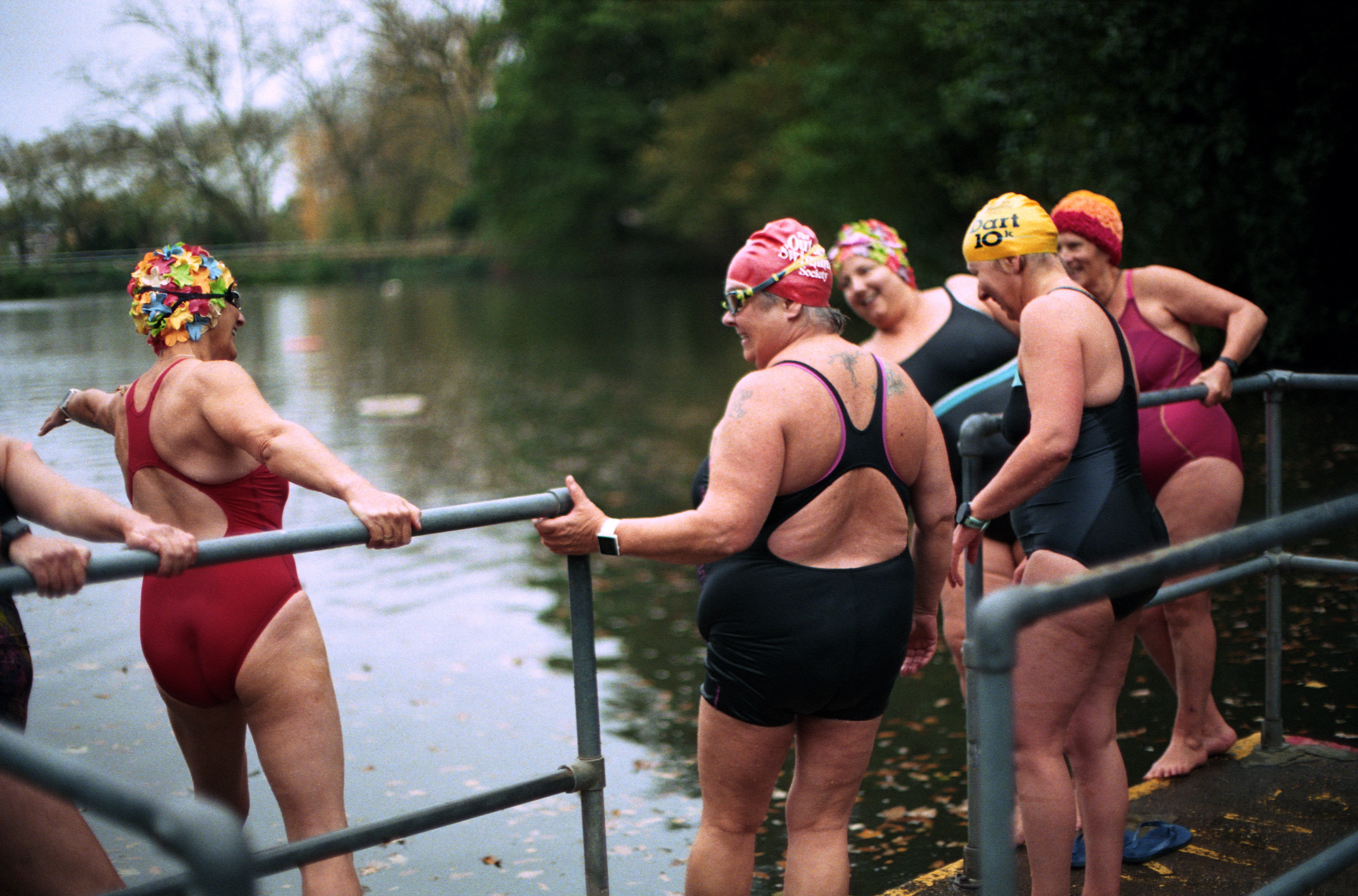a group of people in swimsuits holding a paddle in a river