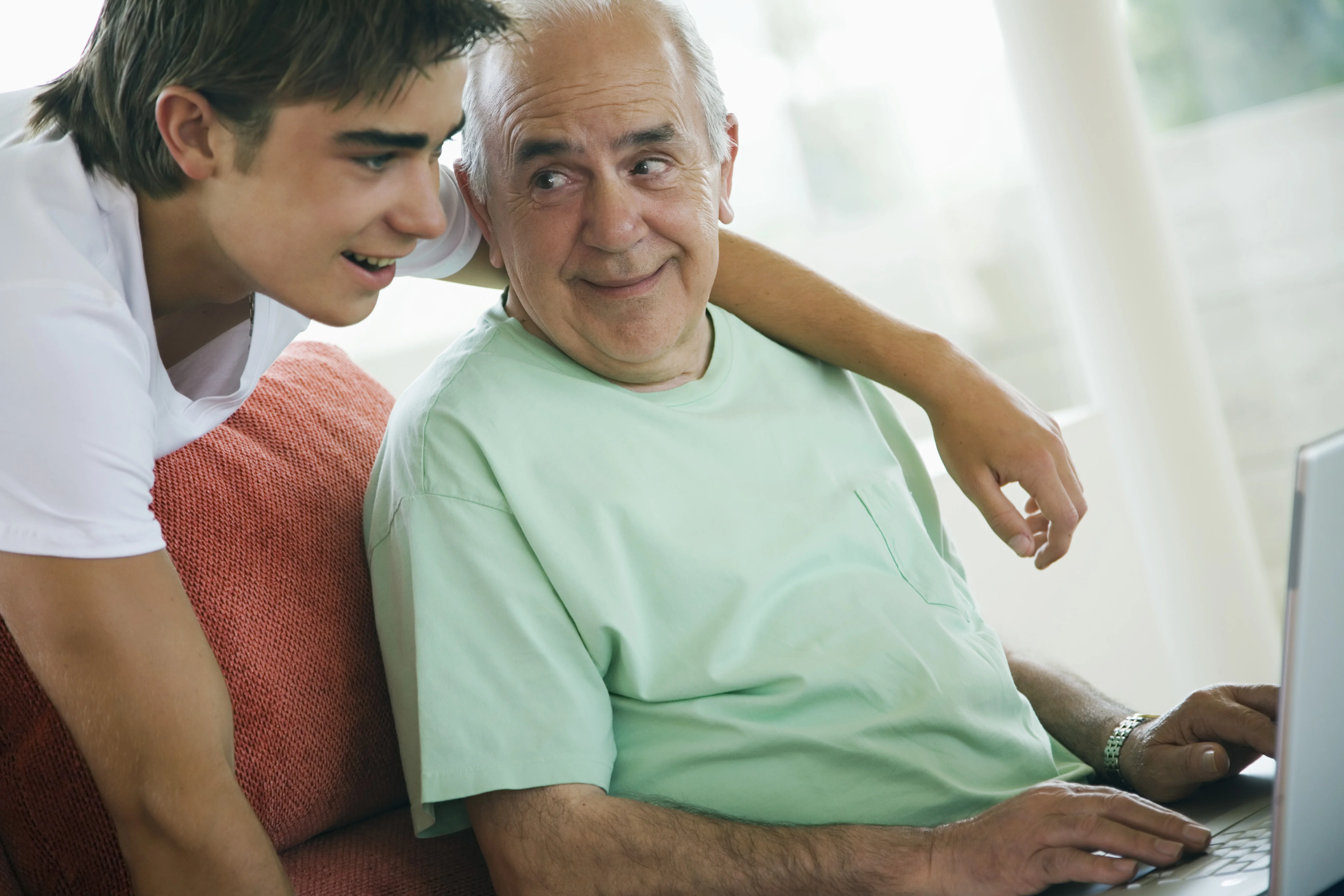a man and a boy looking at a computer screen